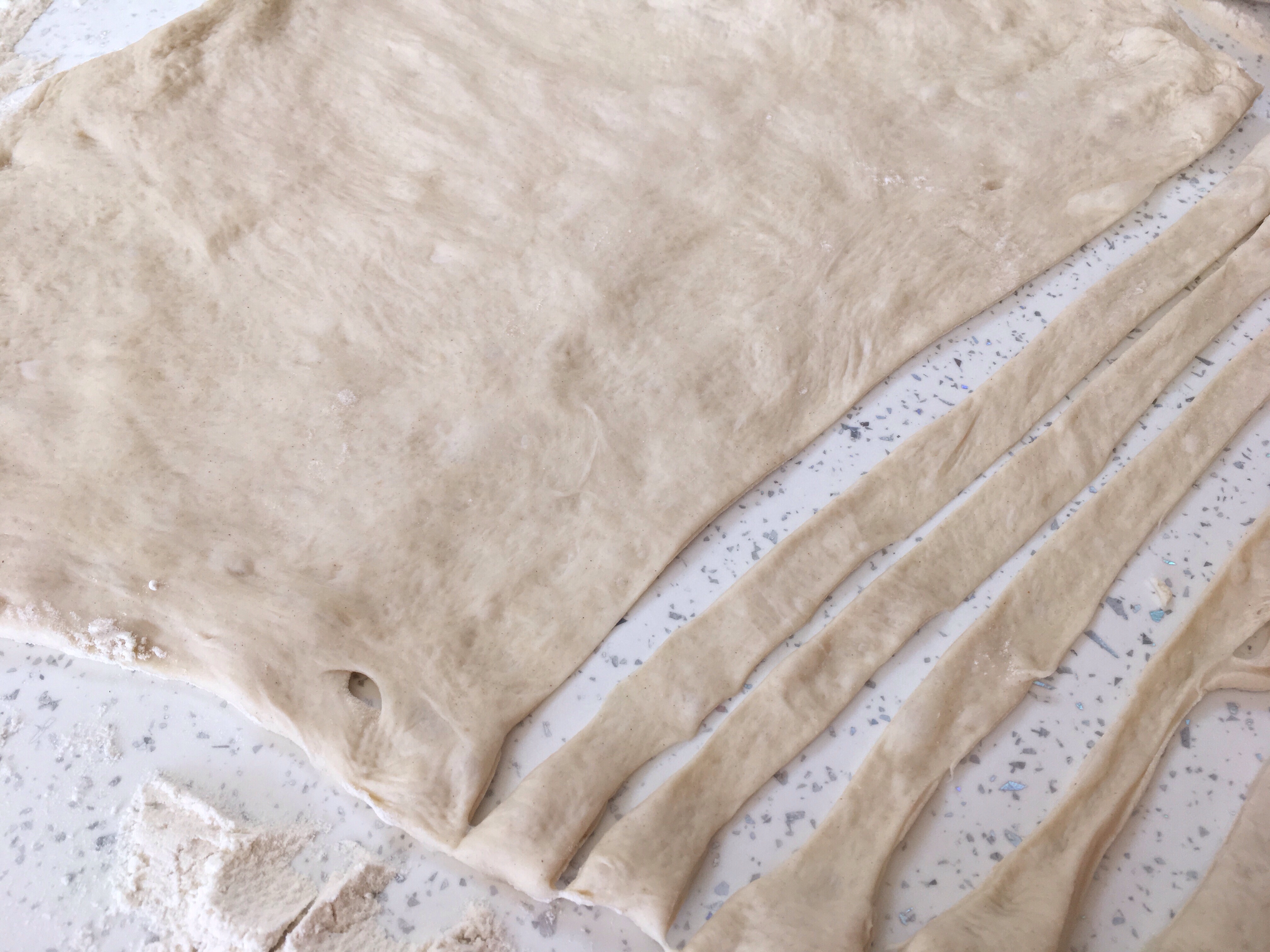 A close up of some dough on top of a table