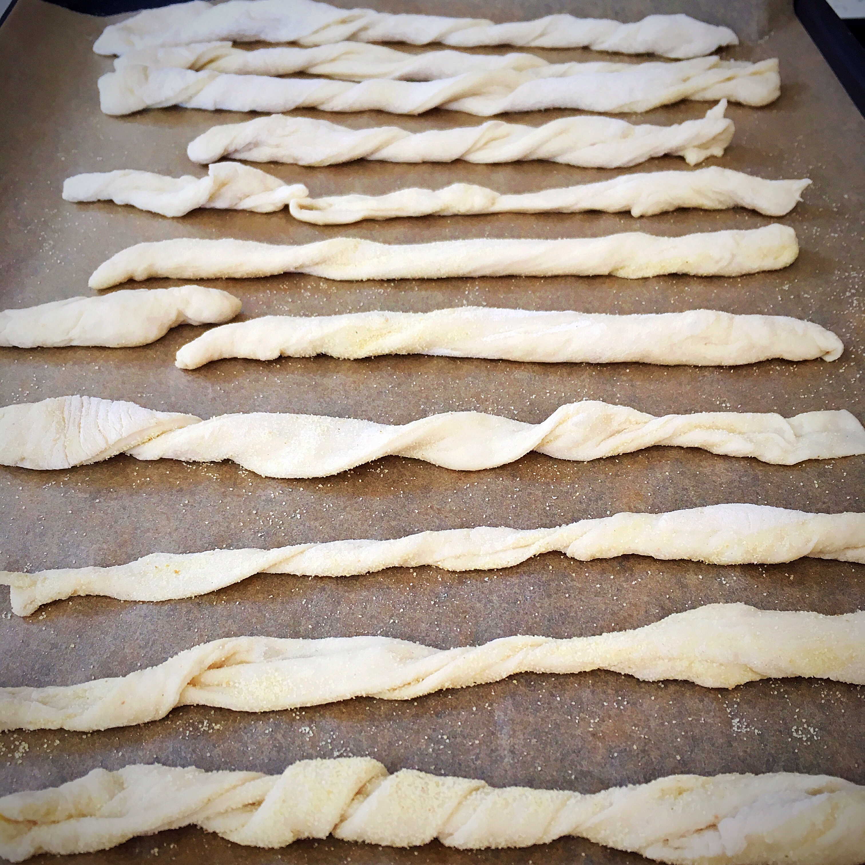 A tray of dough is lined up on the counter.