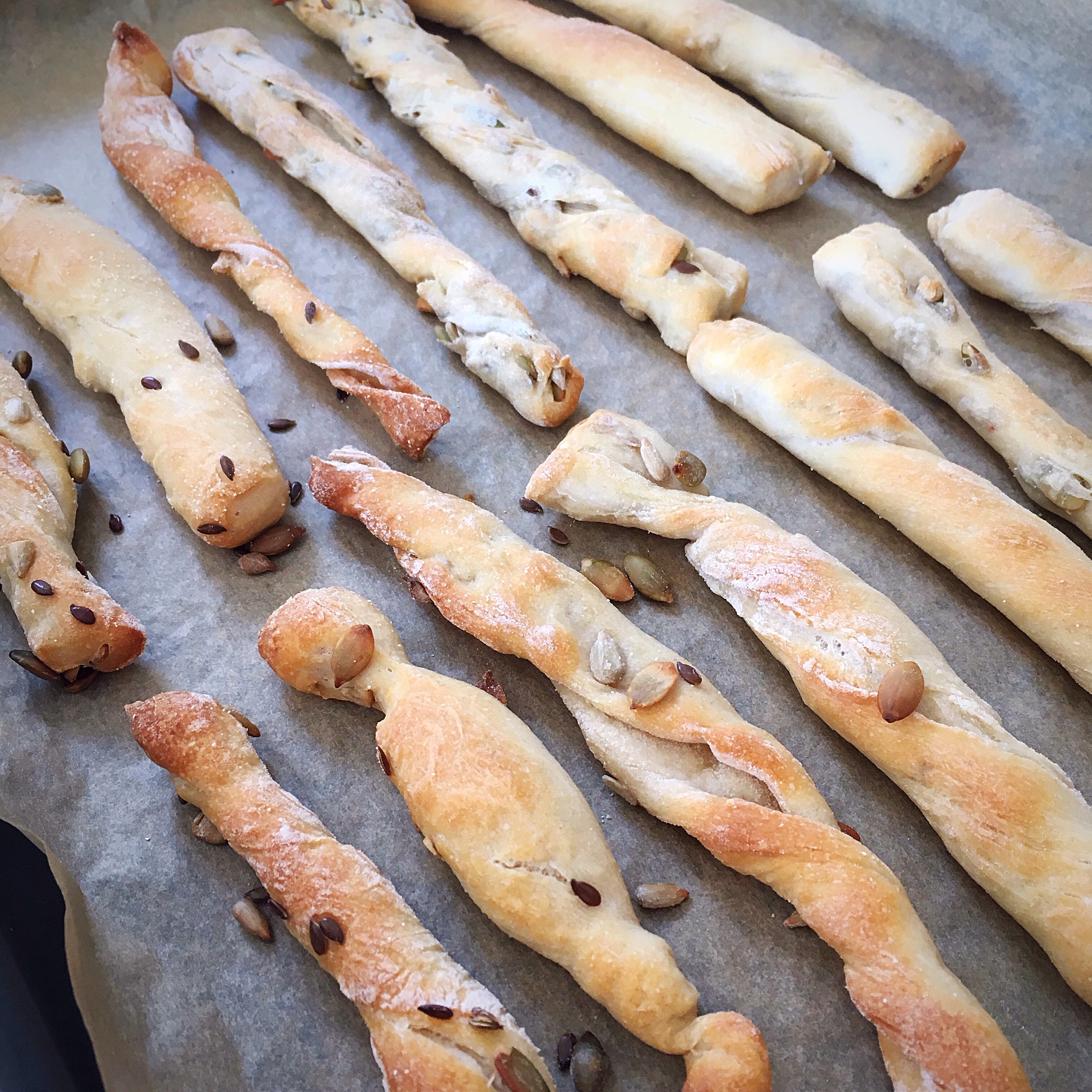 A bunch of bread sticks are on the pan