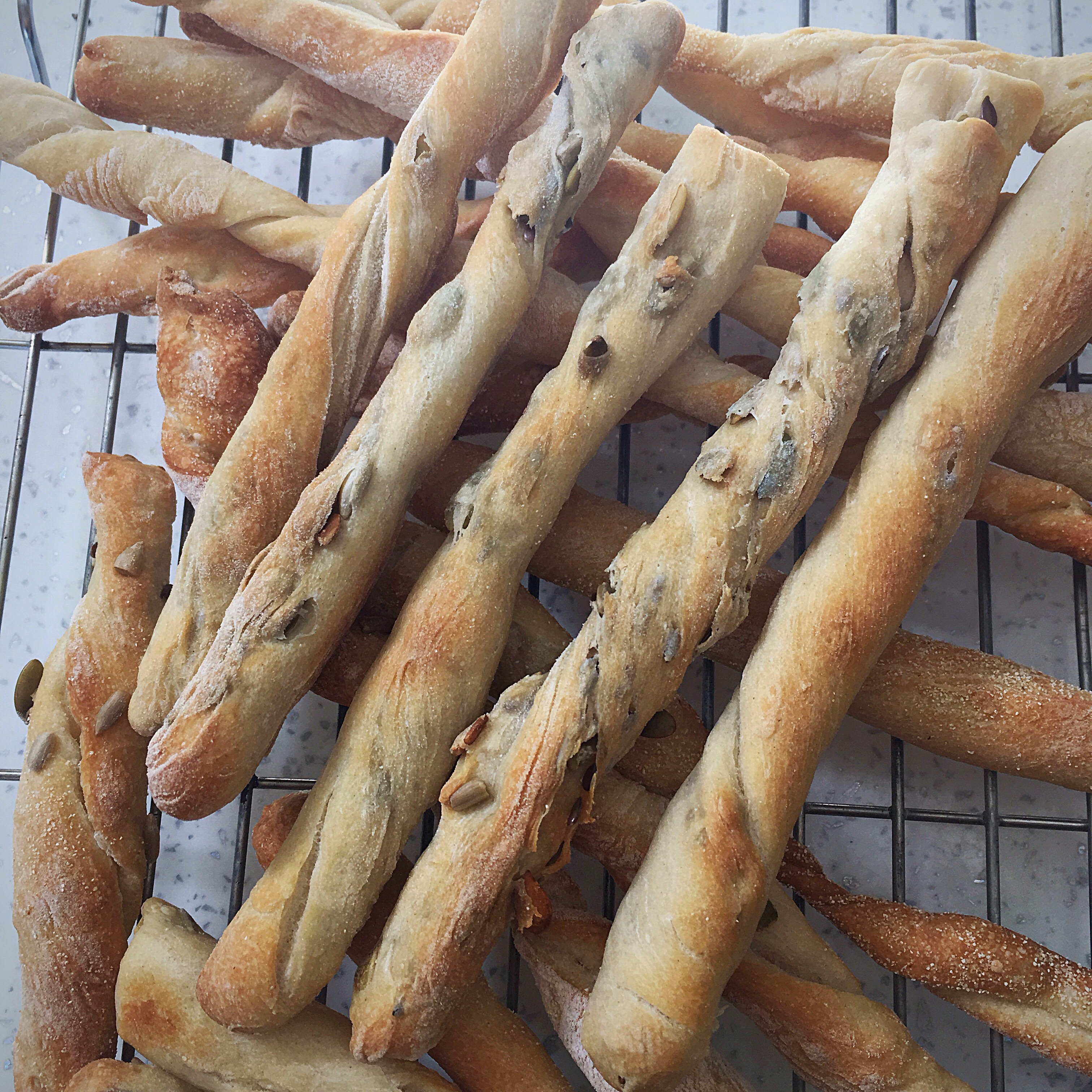 A bunch of bread sticks on a cooling rack