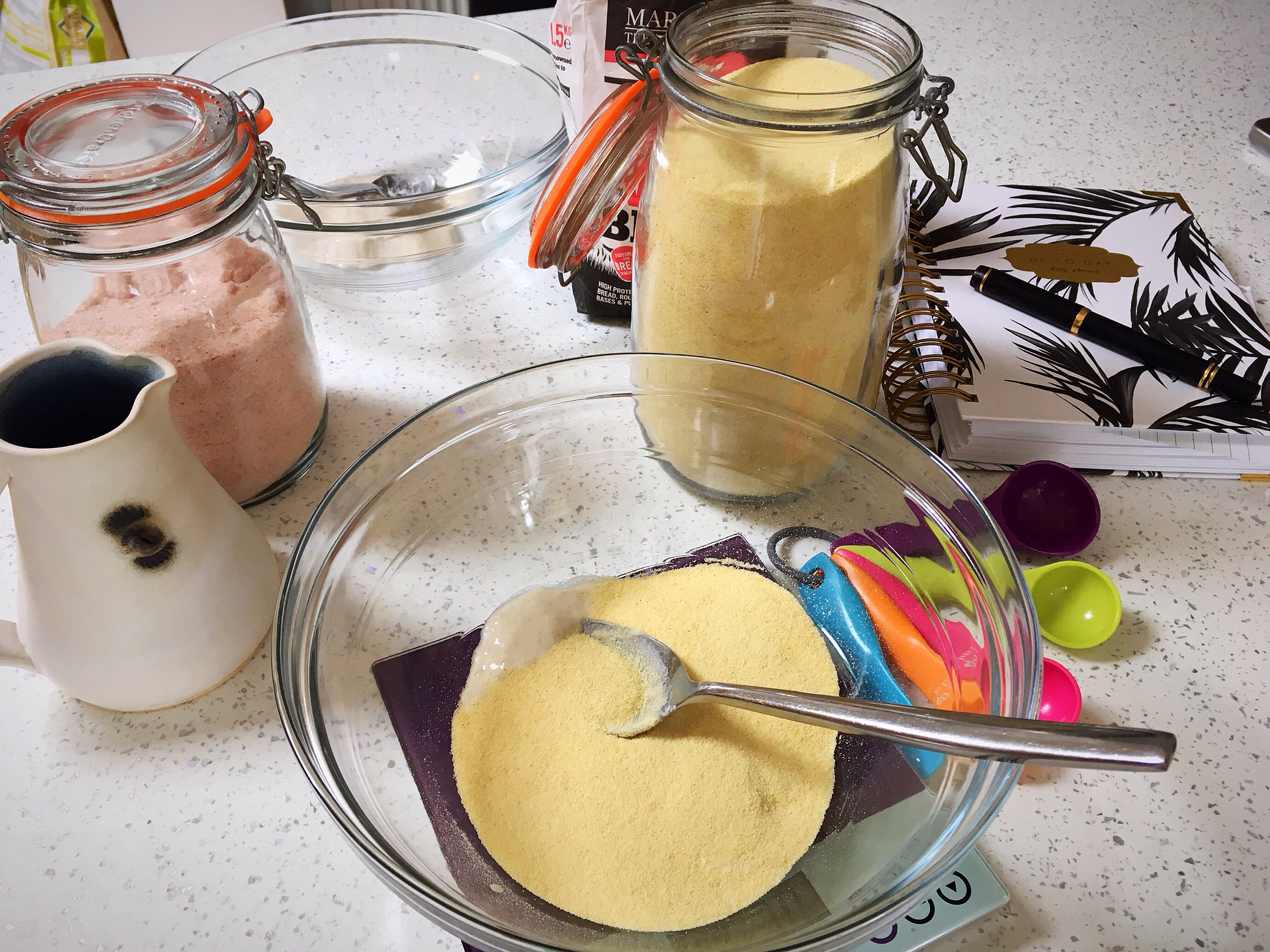 A table with jars and spoons on it