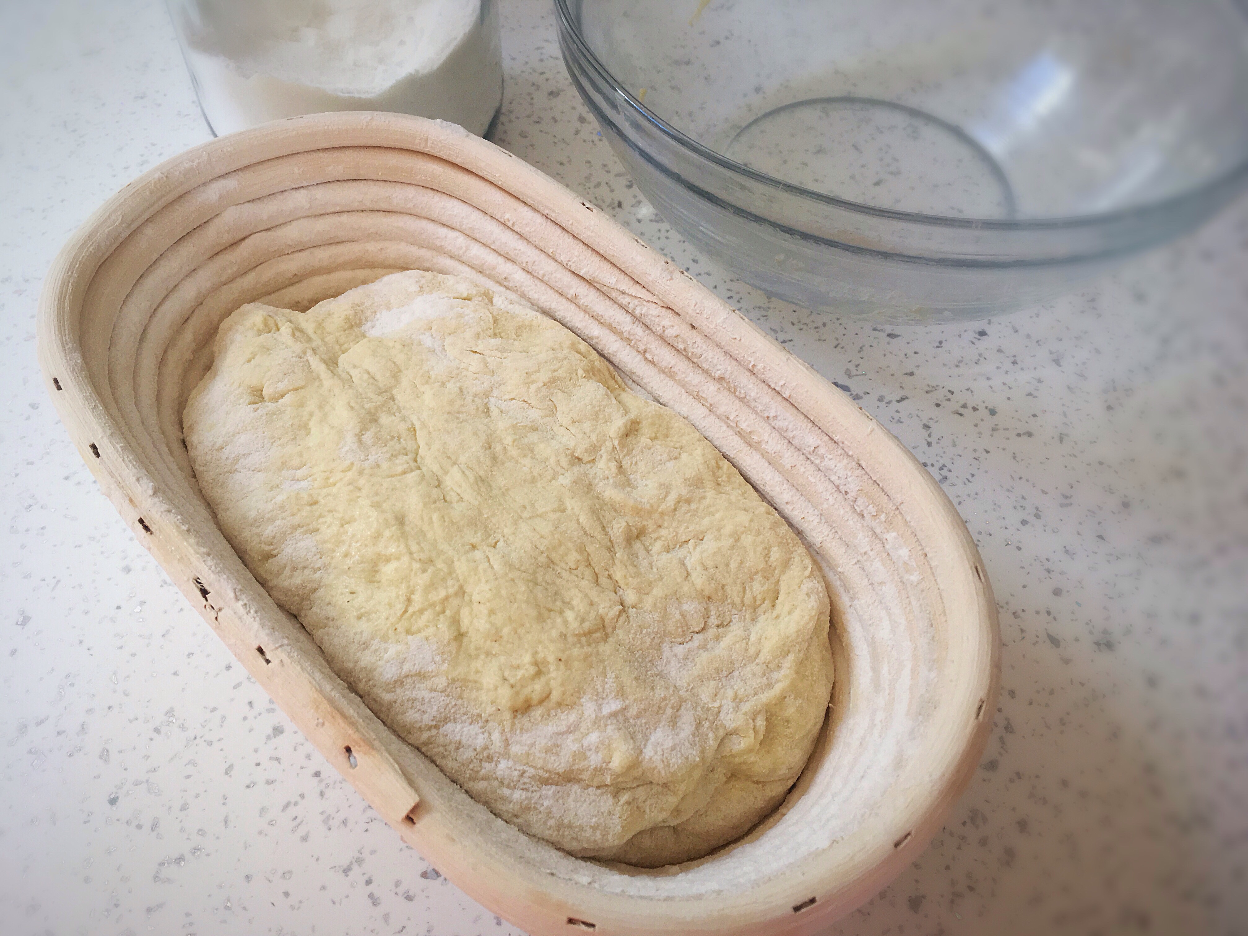 A loaf of bread in a basket on the counter.