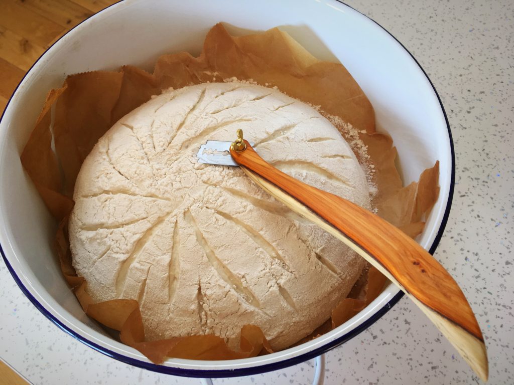 A bowl of food with a wooden spoon in it.