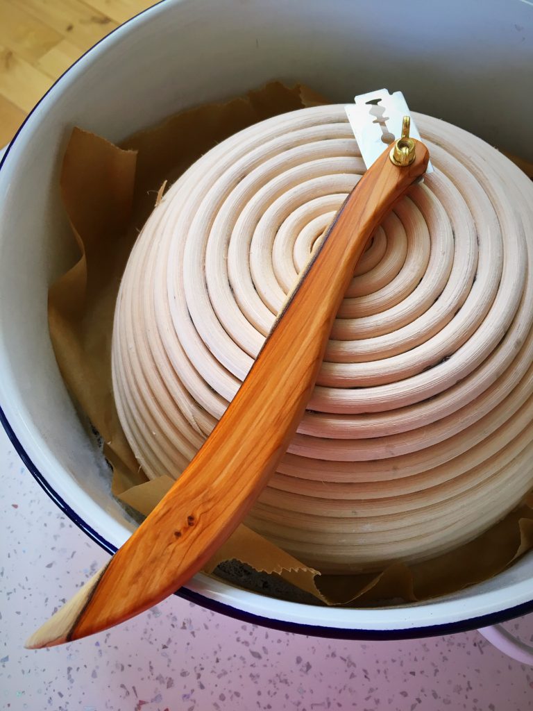 A bowl and wooden spoon in a white bowl.