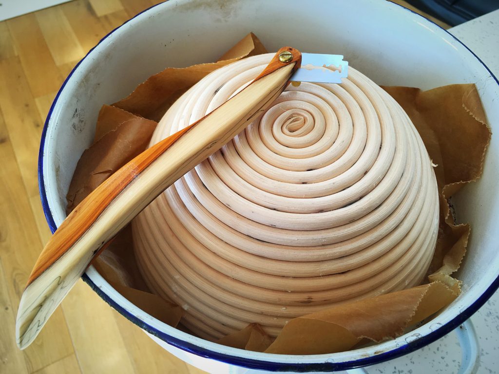 A bowl of food with a wooden spoon in it.