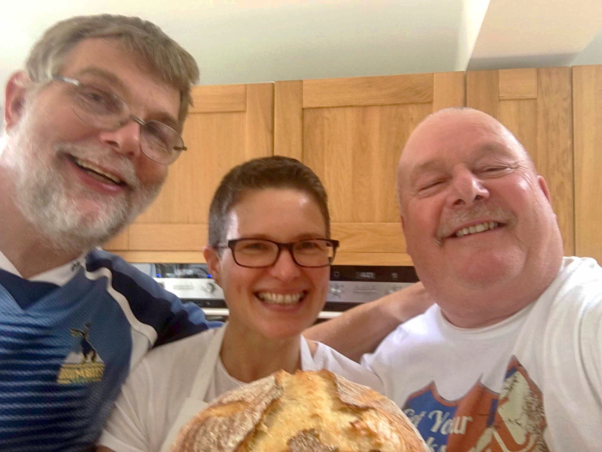 A group of people standing in front of some food.