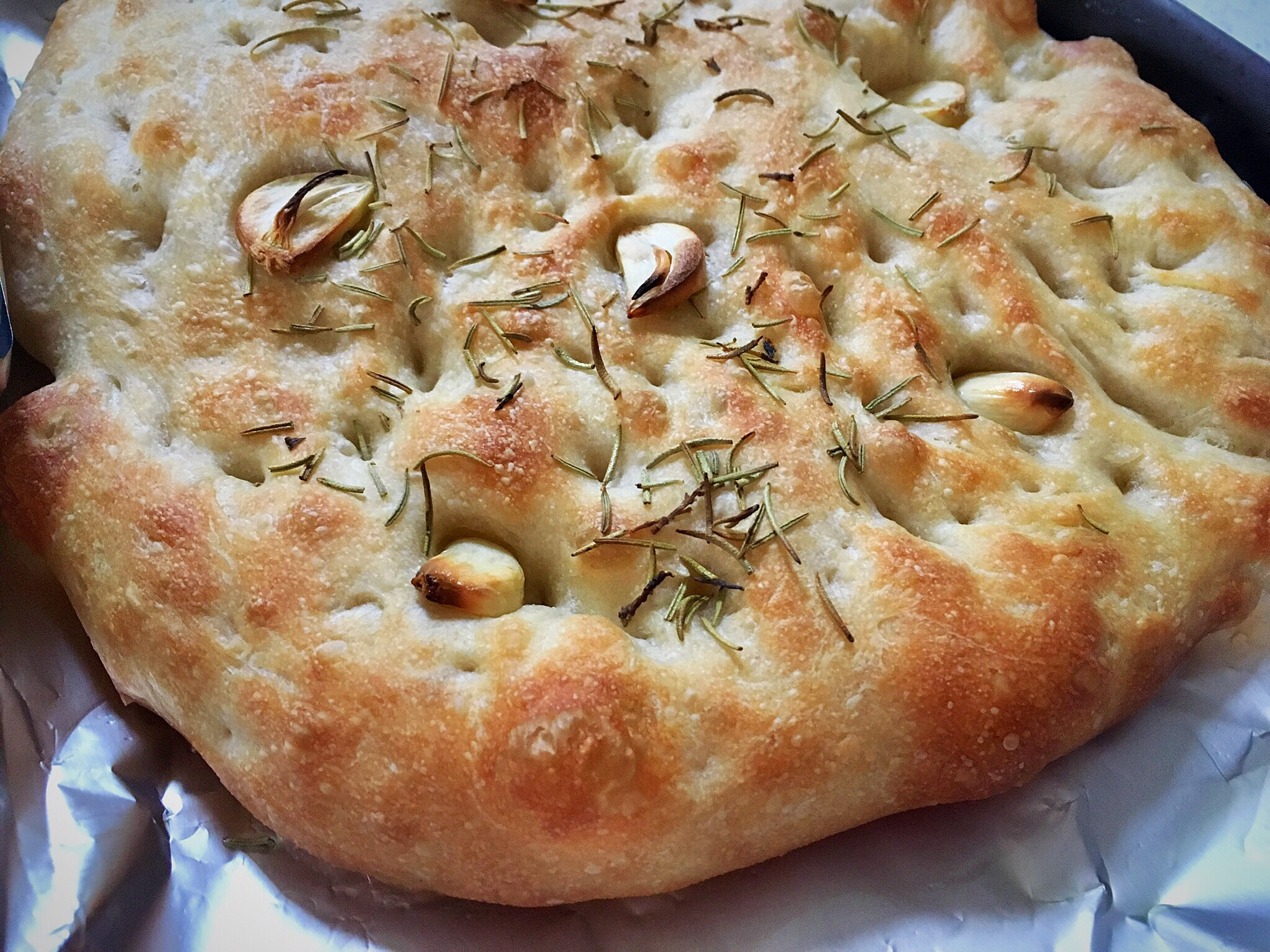 A close up of a pizza with some type of herbs on it