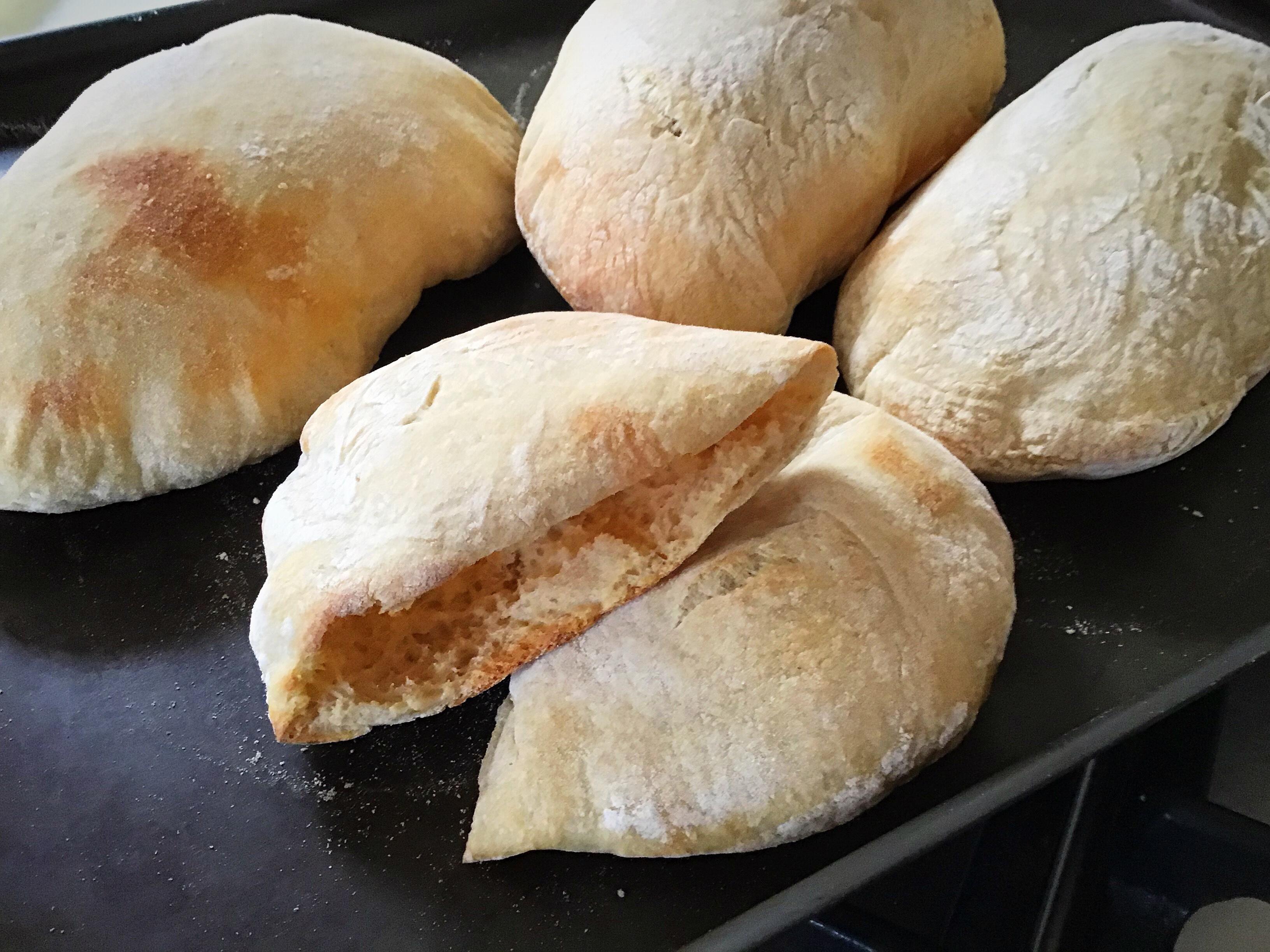 A pan filled with some bread on top of the floor