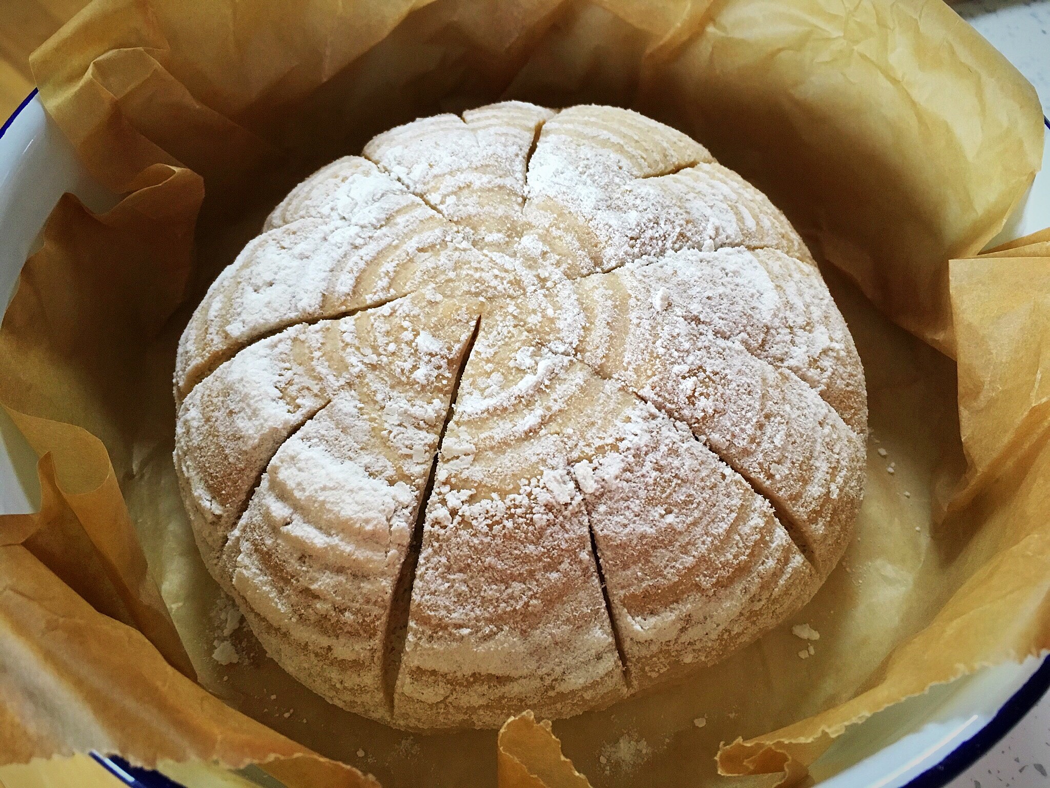 A loaf of bread in a bowl with water.