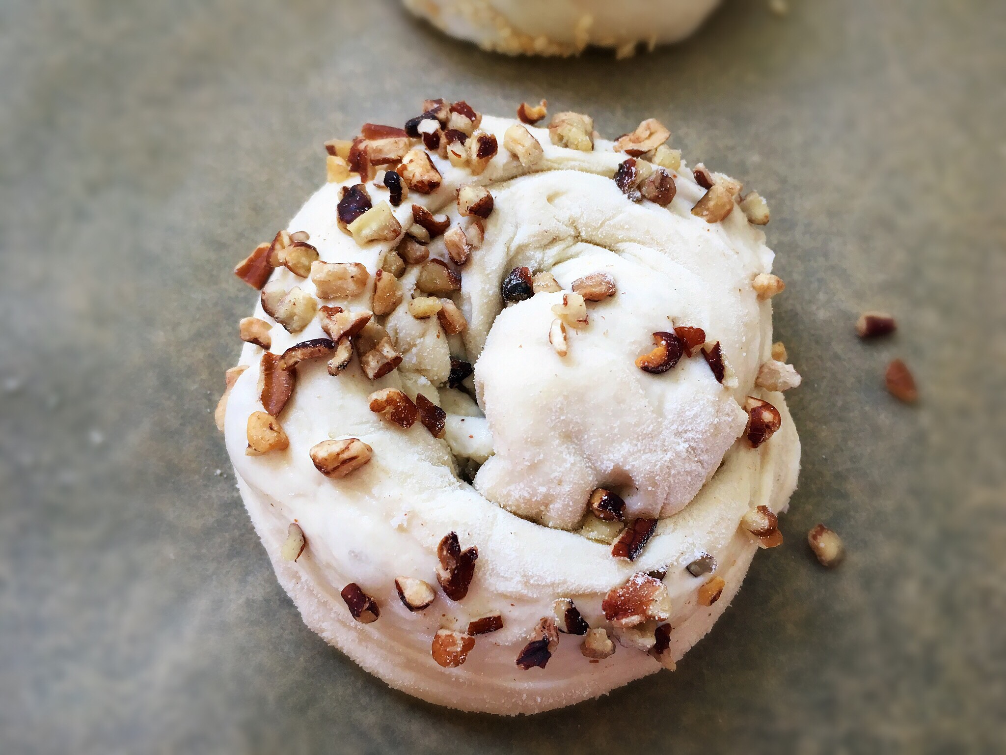 A close up of a pastry with nuts on top