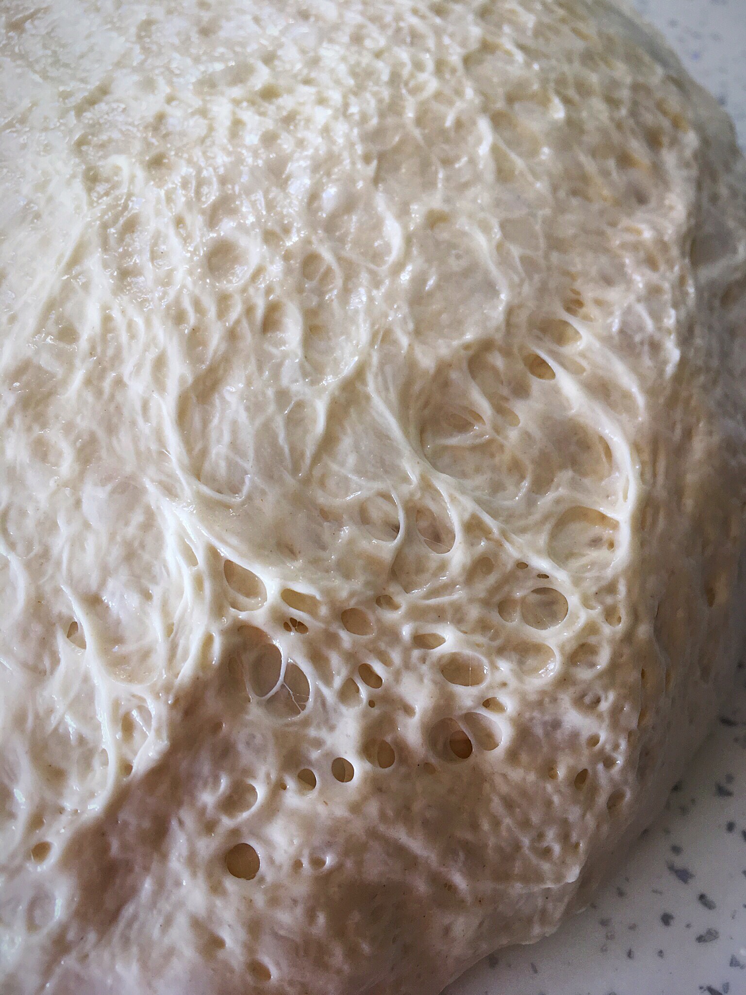 A close up of the crust on a pizza.
