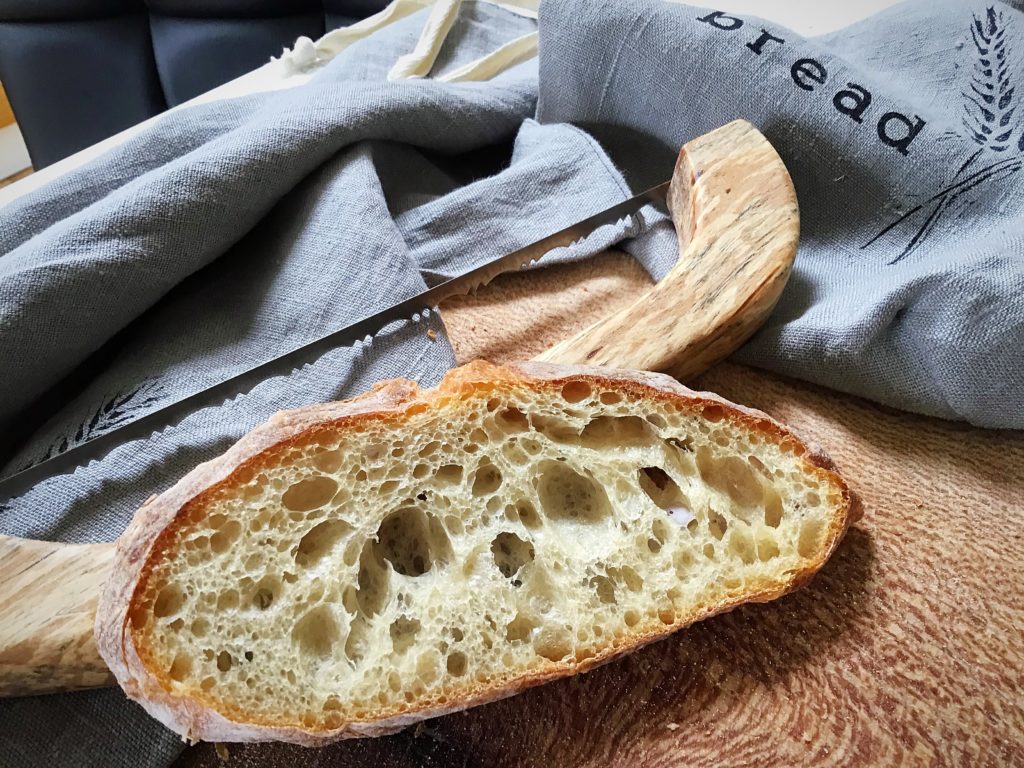 A piece of bread sitting on top of a wooden board.