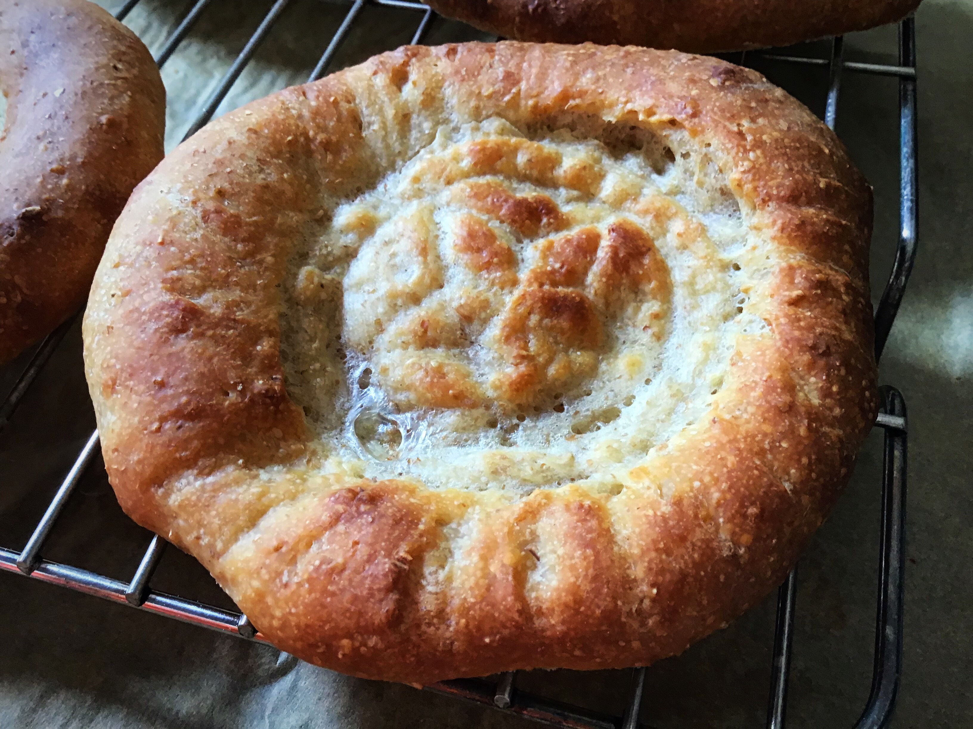 A baked dish on a rack with cheese.