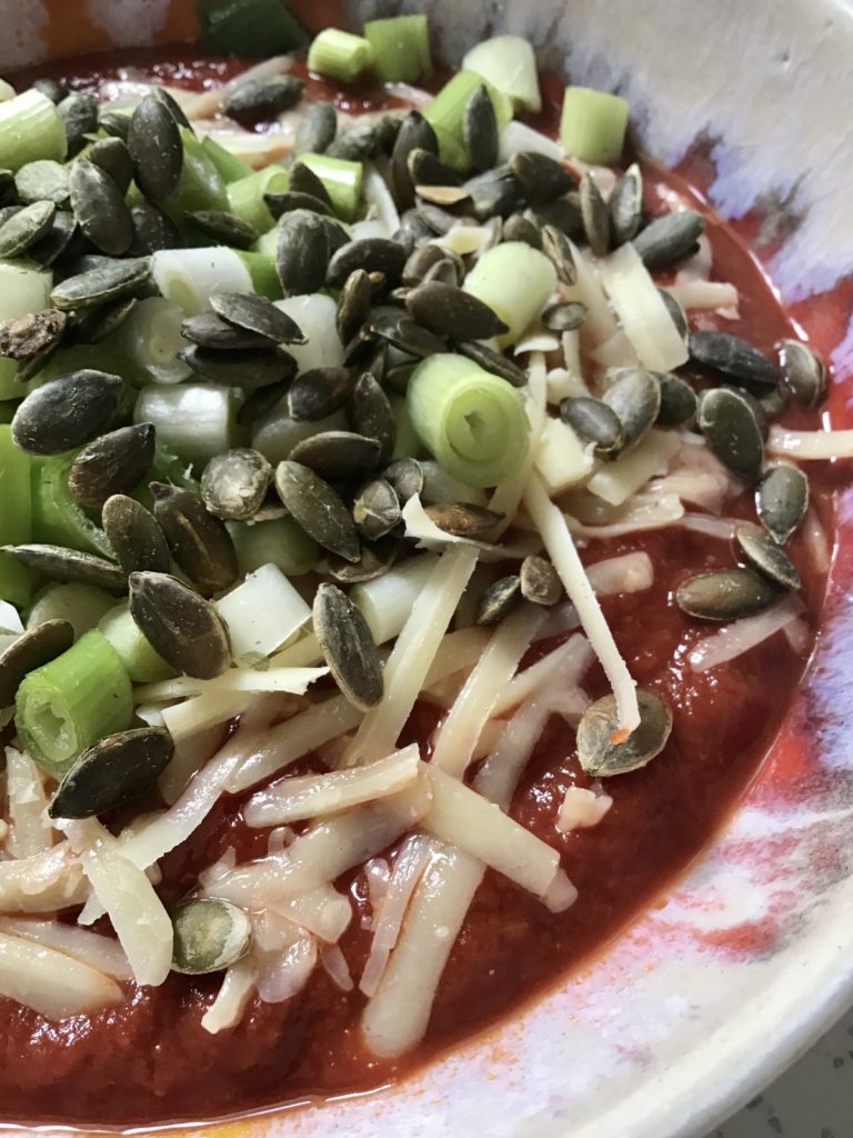 A plate of food with some vegetables and cheese.