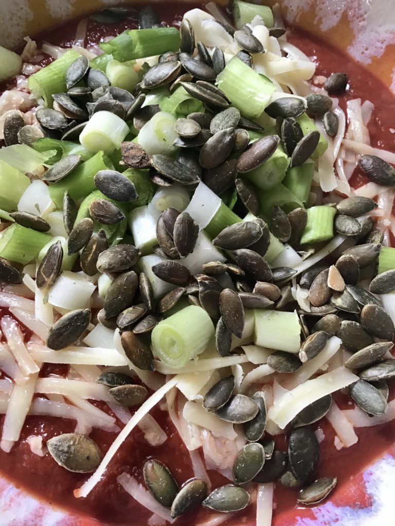 A plate of food with celery, onions and rice.