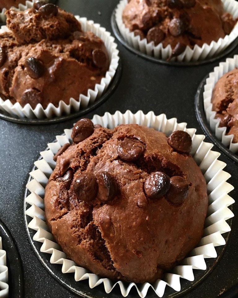 A close up of some chocolate muffins in paper cups