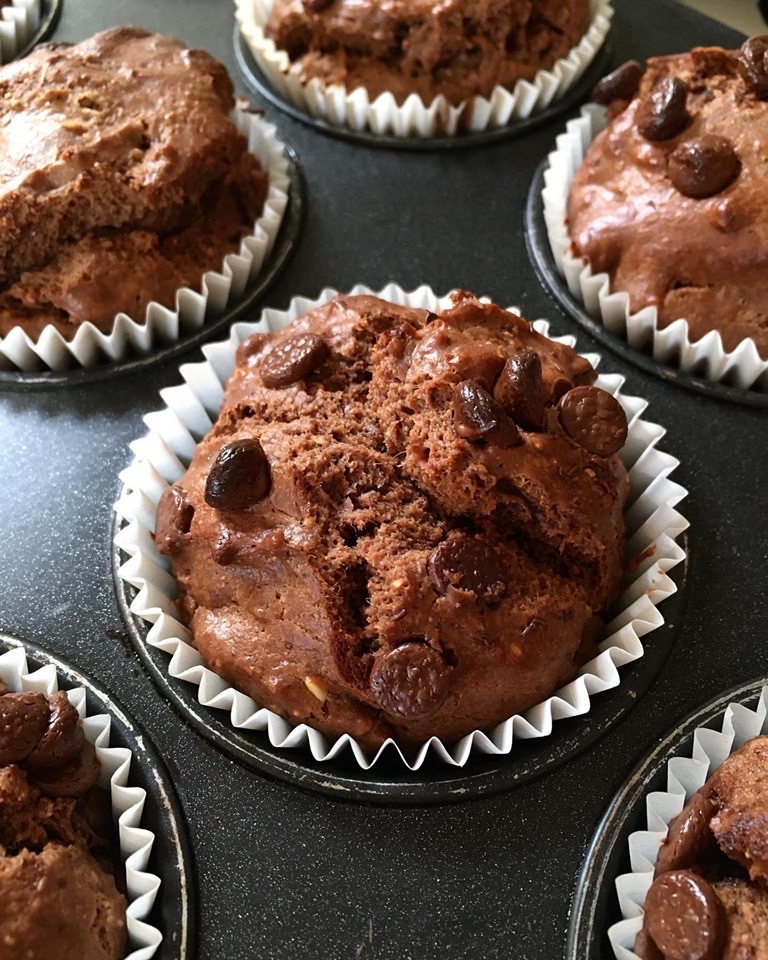 A close up of some chocolate muffins in paper cups
