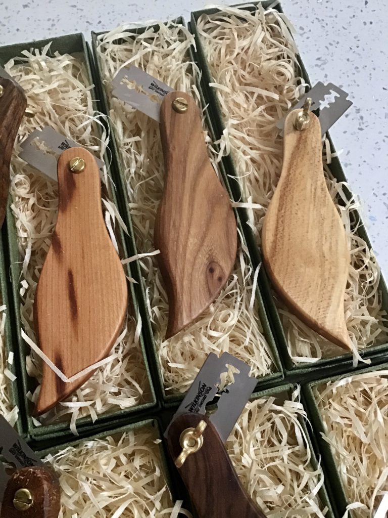 A set of three wooden spoons in a box.