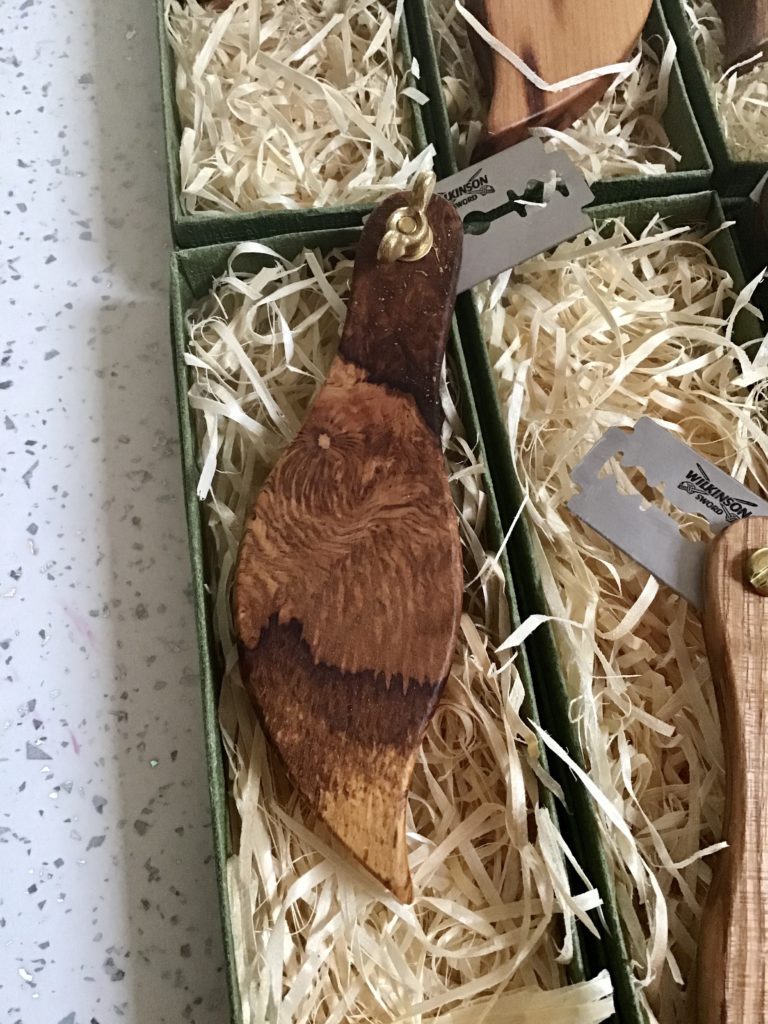 A wooden spoon and fork in a box.