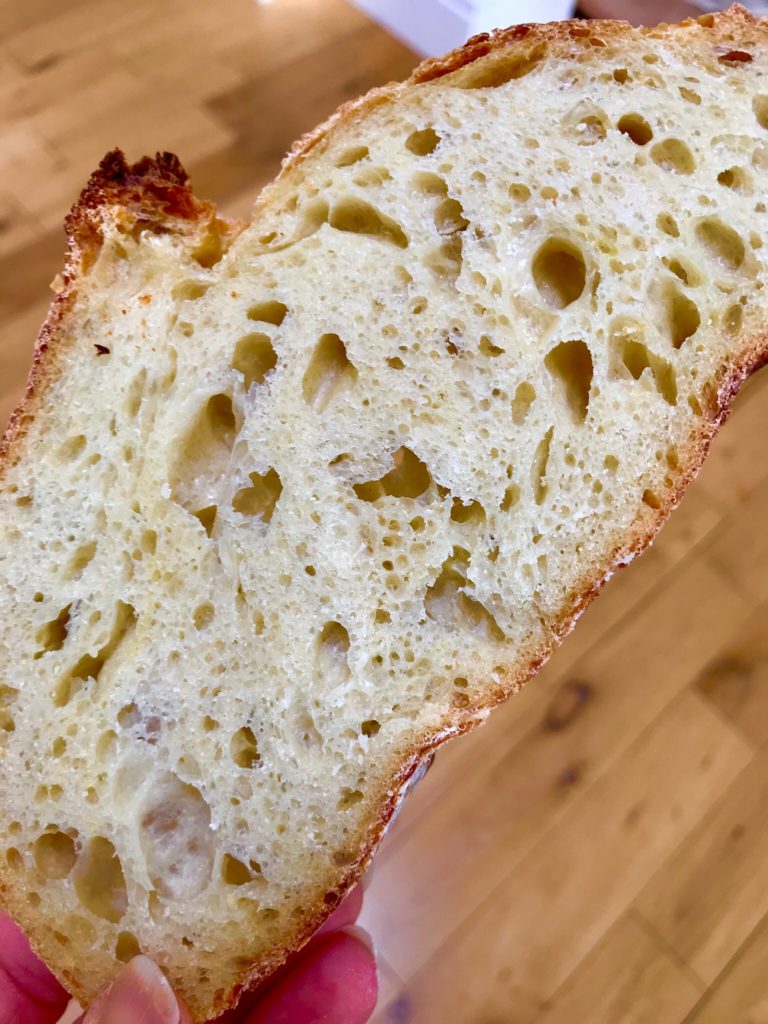 A piece of bread with many holes in it.