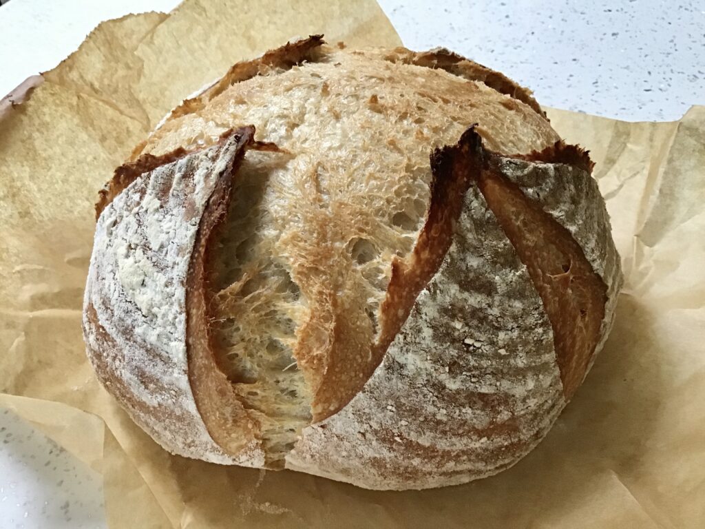 A loaf of bread sitting on top of wax paper.