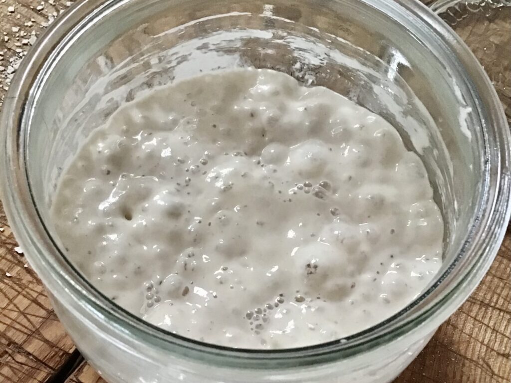 A glass bowl of oatmeal is shown in this image.