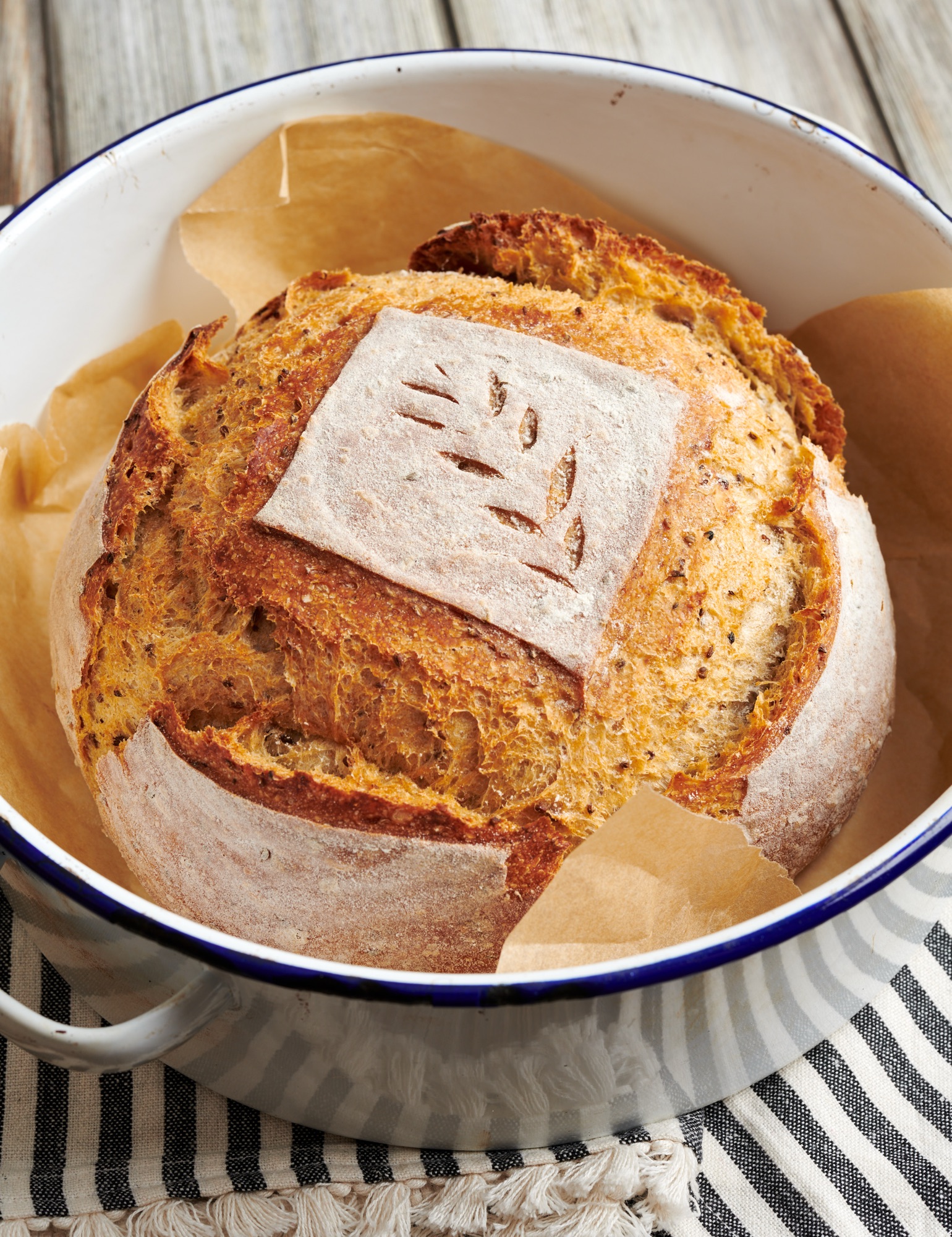 A Scored Loaf Of Sourdough Dough Resting Inside A Dutch Oven Before Going Into The Oven, Illustrating A Key Step In The What Is Cold Baking Process.